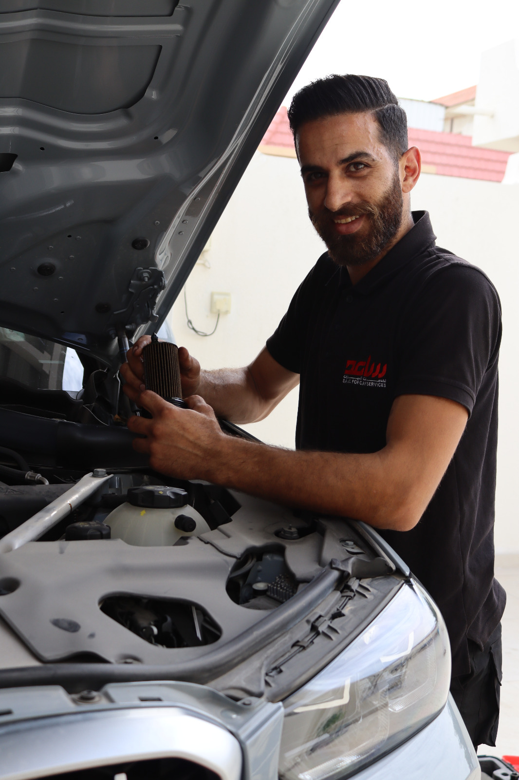 Mobile mechanic working on a car
